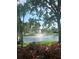 Serene pond view featuring a fountain surrounded by greenery and trees at 10002 Key Haven Rd # 503, Seminole, FL 33777