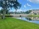 Scenic view of a lush green community with a bridge and peaceful pond at 10002 Key Haven Rd # 503, Seminole, FL 33777