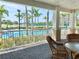 Covered outdoor patio with view of pool and palm trees at 10002 Key Haven Rd # 503, Seminole, FL 33777