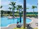 Beautiful community pool, surrounded by lush greenery and lounging areas at 10002 Key Haven Rd # 503, Seminole, FL 33777