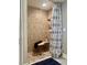 Newly renovated tiled shower with a seating area and modern showerhead at 10002 Key Haven Rd # 503, Seminole, FL 33777