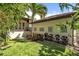 The backyard features artifical turf with a row of green bushes and an adjacent balcony at 101 Bandera Ne Way, St Petersburg, FL 33704