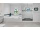 Bright bathroom features a soaking tub, glass shower, and a modern design at 101 Bandera Ne Way, St Petersburg, FL 33704