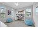 This bedroom features a lofted bed, desk, two windows and two beanbag chairs at 101 Bandera Ne Way, St Petersburg, FL 33704