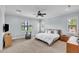 Spacious primary bedroom with a ceiling fan, two windows, and a calming color palette at 101 Bandera Ne Way, St Petersburg, FL 33704