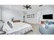 Large primary bedroom showcasing neutral walls, a ceiling fan, and hardwood furniture at 101 Bandera Ne Way, St Petersburg, FL 33704