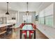 Bright dining room with modern table, red chairs, and hardwood flooring at 101 Bandera Ne Way, St Petersburg, FL 33704