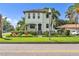Stunning two-story house with vibrant landscaping, set back from the road behind a decorative fence at 101 Bandera Ne Way, St Petersburg, FL 33704