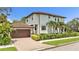 Charming home with a paver driveway leading to a two-car garage and meticulously manicured greenery at 101 Bandera Ne Way, St Petersburg, FL 33704