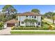 Beautiful two-story home featuring a tile roof, lush landscaping, and an attached garage at 101 Bandera Ne Way, St Petersburg, FL 33704
