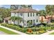 Elegant two-story home with a well-manicured lawn and tropical landscaping at 101 Bandera Ne Way, St Petersburg, FL 33704