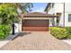 A paver driveway leads to a well-maintained two-car garage with a new roof and manicured landscaping at 101 Bandera Ne Way, St Petersburg, FL 33704
