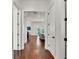 Bright hallway with hardwood floors, leading to a light-filled living area and inviting balcony at 101 Bandera Ne Way, St Petersburg, FL 33704