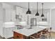 Modern kitchen featuring a large island, stainless steel appliances, and white cabinetry at 101 Bandera Ne Way, St Petersburg, FL 33704