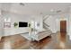 Open-concept living room with hardwood floors, shiplap accent wall, and staircase leading to the upper level at 101 Bandera Ne Way, St Petersburg, FL 33704