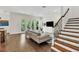 Comfortable living room with hardwood floors, shiplap wall, and access to an outdoor balcony at 101 Bandera Ne Way, St Petersburg, FL 33704