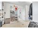 A walk-in closet with custom shelving and cabinetry and hardwood floors throughout at 101 Bandera Ne Way, St Petersburg, FL 33704