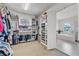 Spacious walk-in closet with custom shelving and cabinetry, leading to the bathroom at 101 Bandera Ne Way, St Petersburg, FL 33704