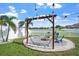 Backyard with pergola, hammock, pond, and string lights at 10624 Aldo Moro Dr, Wimauma, FL 33598