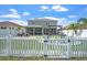 Spacious backyard featuring a fire pit area, screened in porch, and white picket fence at 10624 Aldo Moro Dr, Wimauma, FL 33598