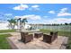 Beautiful backyard with outdoor seating, fire pit, hammock, and string lights at 10624 Aldo Moro Dr, Wimauma, FL 33598