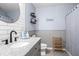 Bathroom featuring granite countertop, round mirror and subway tile wall at 10624 Aldo Moro Dr, Wimauma, FL 33598