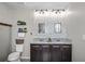 Bathroom with double vanity, updated fixtures, and a stylish backsplash, creating a modern and functional space at 10624 Aldo Moro Dr, Wimauma, FL 33598