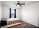 Simple bedroom featuring hardwood floors, a ceiling fan and a window at 10624 Aldo Moro Dr, Wimauma, FL 33598