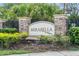 Elegant Mirabella community sign, with stone pillars and lush landscaping at 10624 Aldo Moro Dr, Wimauma, FL 33598
