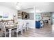 Open dining room features stylish decor, wood floors, and seamless flow to living area at 10624 Aldo Moro Dr, Wimauma, FL 33598