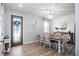Bright dining room with wood floors, a decorative door, and elegant chandelier lighting at 10624 Aldo Moro Dr, Wimauma, FL 33598