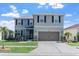 Charming two-story home features a well-manicured lawn and an attached two-car garage at 10624 Aldo Moro Dr, Wimauma, FL 33598