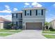 Beautiful two-story home with a two-car garage, well-maintained lawn, and lovely landscaping at 10624 Aldo Moro Dr, Wimauma, FL 33598