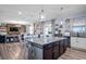 Spacious kitchen with granite countertops, center island, stainless appliances, and open floor plan at 10624 Aldo Moro Dr, Wimauma, FL 33598