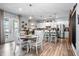 Open kitchen and dining area with modern appliances, an island, and a view of the patio at 10624 Aldo Moro Dr, Wimauma, FL 33598