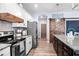 Kitchen featuring modern appliances, granite countertops, and wood accents at 10624 Aldo Moro Dr, Wimauma, FL 33598