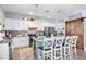 Modern kitchen with stainless steel appliances, granite countertops, white cabinets, and a wooden sliding door at 10624 Aldo Moro Dr, Wimauma, FL 33598