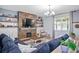 Cozy living room features a stone fireplace, built-in shelving, and comfortable seating at 10624 Aldo Moro Dr, Wimauma, FL 33598