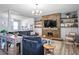 Inviting living area with stylish stone fireplace, open shelving, and hardwood flooring at 10624 Aldo Moro Dr, Wimauma, FL 33598