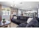 Bright open living area featuring a comfortable sectional sofa and a view of the modern kitchen at 10624 Aldo Moro Dr, Wimauma, FL 33598