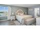 Main bedroom featuring a lake view, decorative wall, and a cozy seating area for a relaxing retreat at 10624 Aldo Moro Dr, Wimauma, FL 33598
