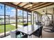 Relaxing screened-in patio with dining table and hanging swing chair at 10624 Aldo Moro Dr, Wimauma, FL 33598