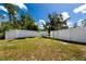 Wide backyard with white vinyl fencing, creating a private outdoor space, and mature trees adding character at 11203 Egret Nest Ct, Riverview, FL 33569