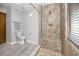 Tiled bathroom featuring walk-in shower, toilet, and modern fixtures at 11203 Egret Nest Ct, Riverview, FL 33569