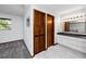 Bathroom features modern fixtures, a dark countertop, wooden doors, and gray tile flooring at 11203 Egret Nest Ct, Riverview, FL 33569
