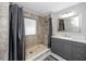 Bathroom with a tiled walk-in shower and modern vanity with neutral color palette at 11203 Egret Nest Ct, Riverview, FL 33569
