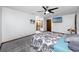 Comfortable bedroom featuring soft carpet, ceiling fan, and a TV for entertainment at 11203 Egret Nest Ct, Riverview, FL 33569
