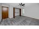 Inviting bedroom with gray carpet, a ceiling fan, and a closet with wooden bi-fold doors at 11203 Egret Nest Ct, Riverview, FL 33569