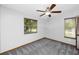 Bedroom features a ceiling fan, two windows, and neutral walls, and gray carpet at 11203 Egret Nest Ct, Riverview, FL 33569