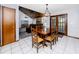 A dining area featuring a wooden table set, wood ceiling, and seamless flow to the adjacent living room at 11203 Egret Nest Ct, Riverview, FL 33569